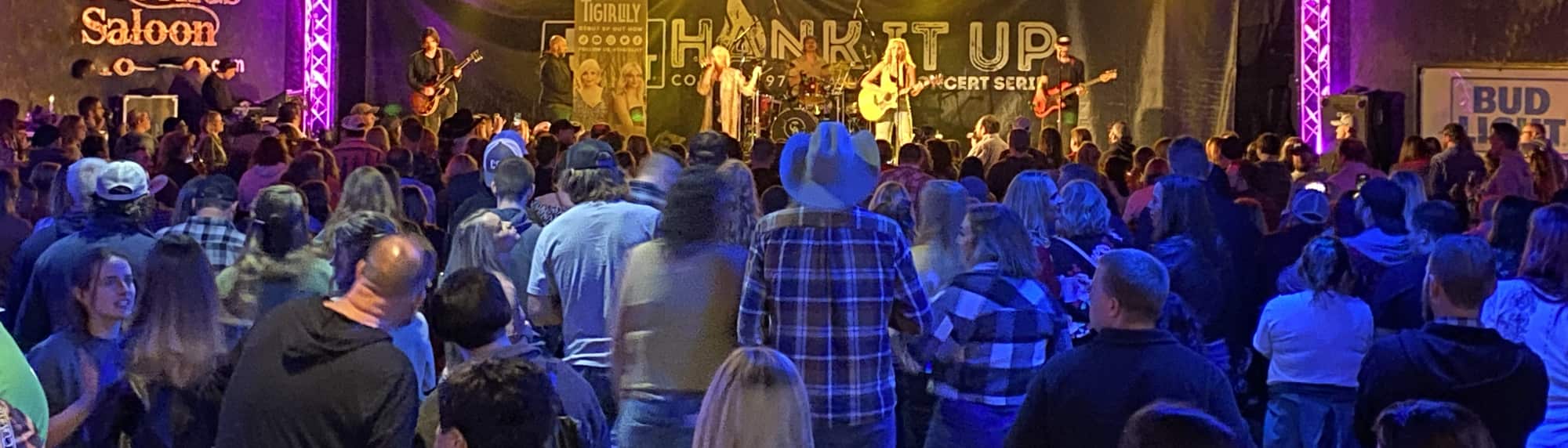 country concert with fans wearing cowboy hats Riverside