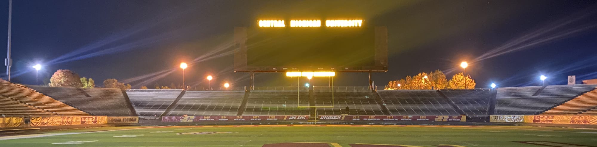 empty football stadium at night under the lights Riverside